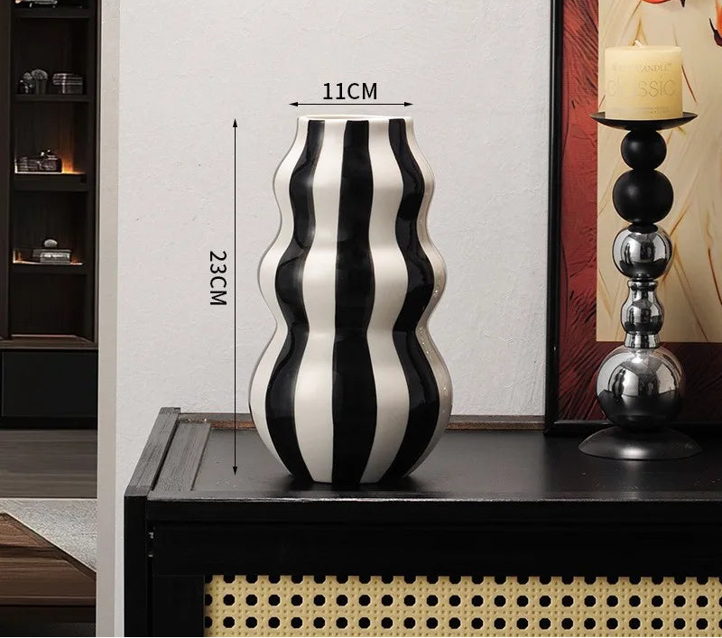 Black and white striped vase on a table with dimensions displayed